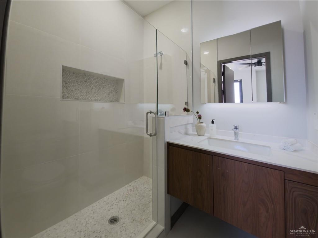 1120 East Santa Rosa Street Edinburg, TX 78542 - Photo 12 of 14 a bathroom with a bath tub sink mirror and shower