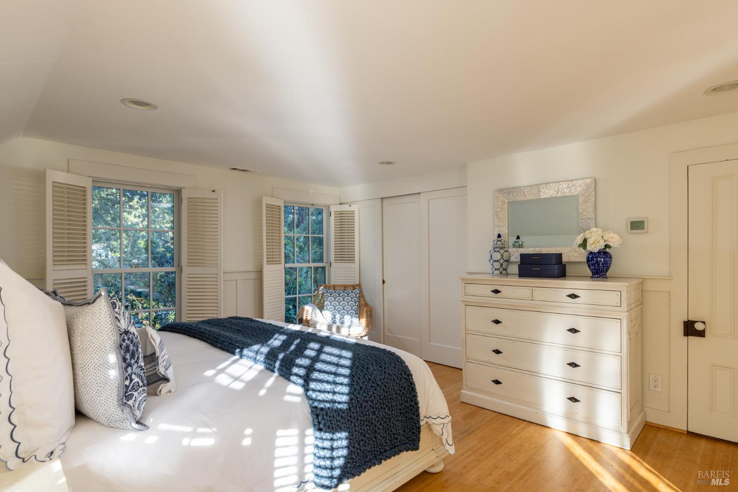 1410 Adams Street St. Helena, CA 94574 - Photo 21 of 46 a bedroom with a bed and large windows