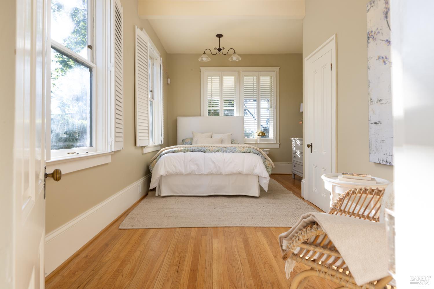 1410 Adams Street St. Helena, CA 94574 - Photo 25 of 46 a bedroom with a bed and wooden floor