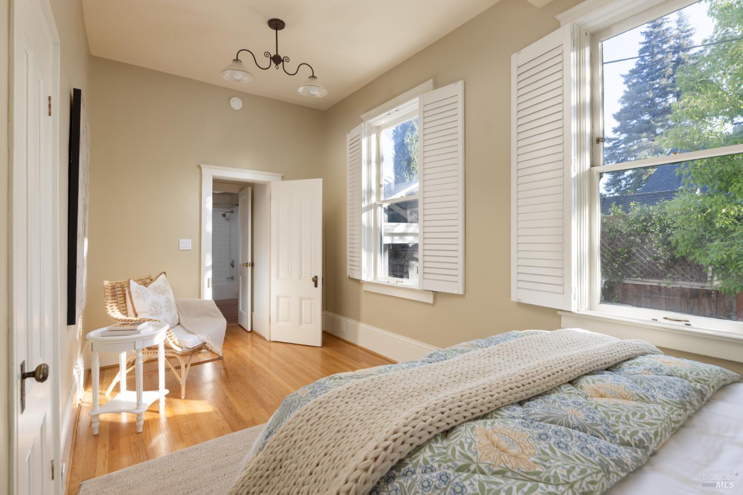 1410 Adams Street St. Helena, CA 94574 - Photo 26 of 46 a spacious bedroom with a bed and wooden floor