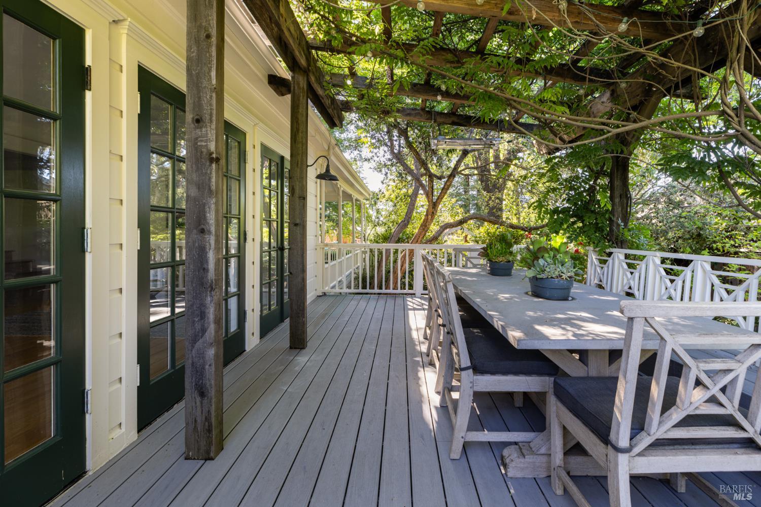 1410 Adams Street St. Helena, CA 94574 - Photo 42 of 46 a view of a patio with table and chairs with wooden floor and fence