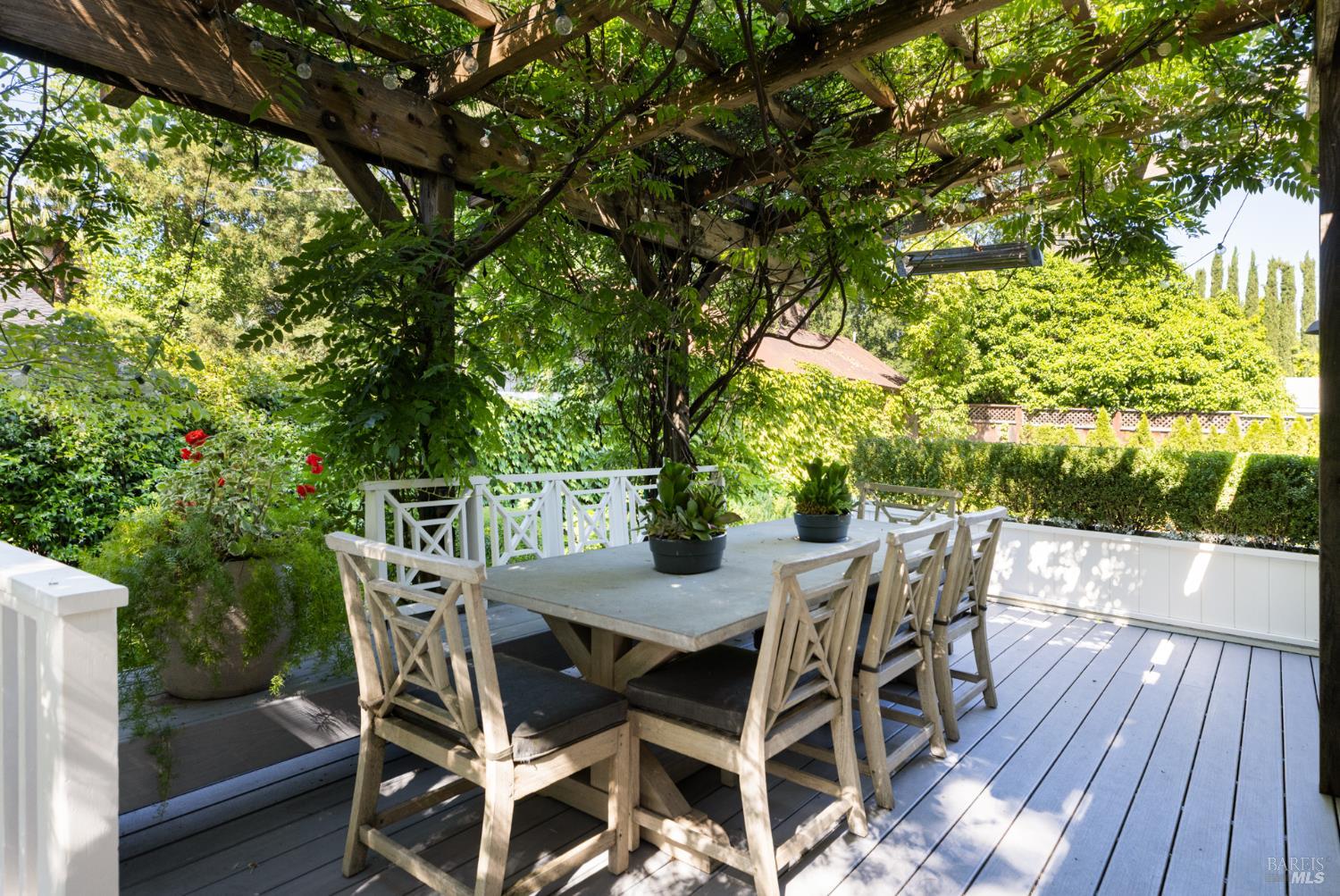 1410 Adams Street St. Helena, CA 94574 - Photo 44 of 46 a view of a backyard with table and chairs with wooden floor and fence