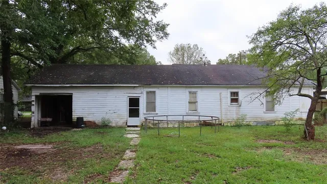 a front view of house with yard and trees