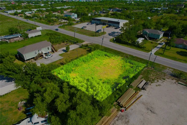 an aerial view of a house with a yard basket ball court and outdoor seating