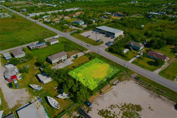an aerial view of a houses with a yard and lake view