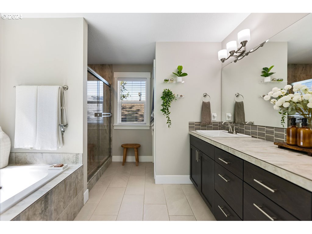 327 South 39th Drive Ridgefield, WA 98642 - Photo 25 of 48 a spacious bathroom with a granite countertop sink a mirror and a bathtub
