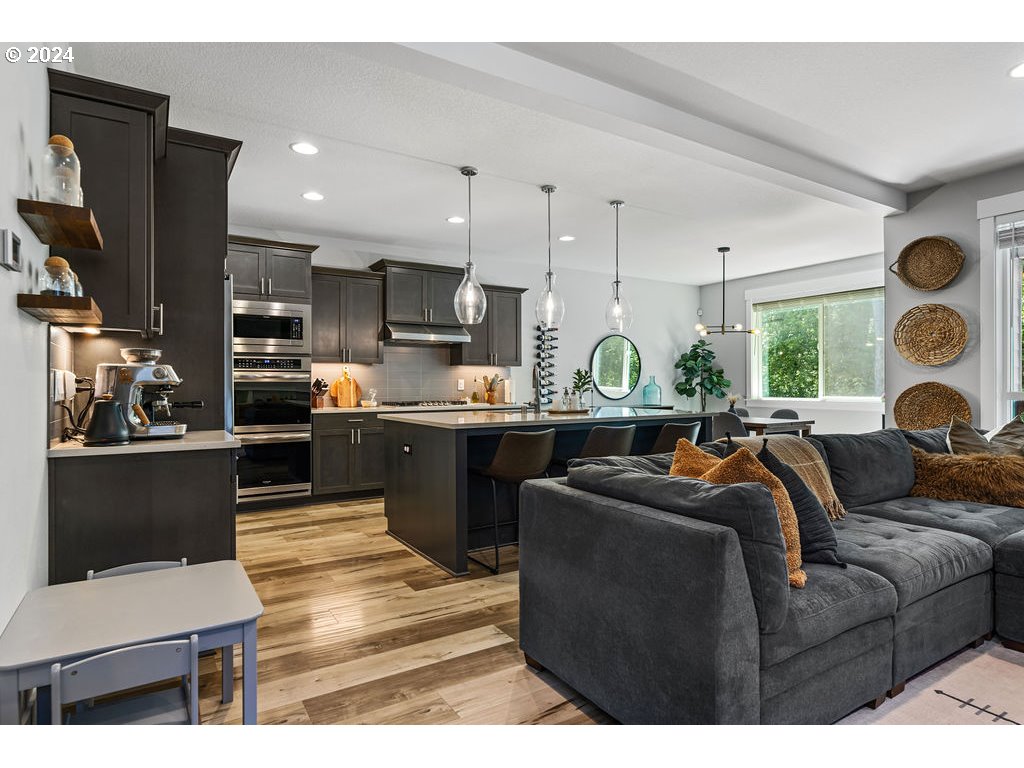 327 South 39th Drive Ridgefield, WA 98642 - Photo 6 of 48 a living room with stainless steel appliances kitchen island granite countertop furniture and a large window
