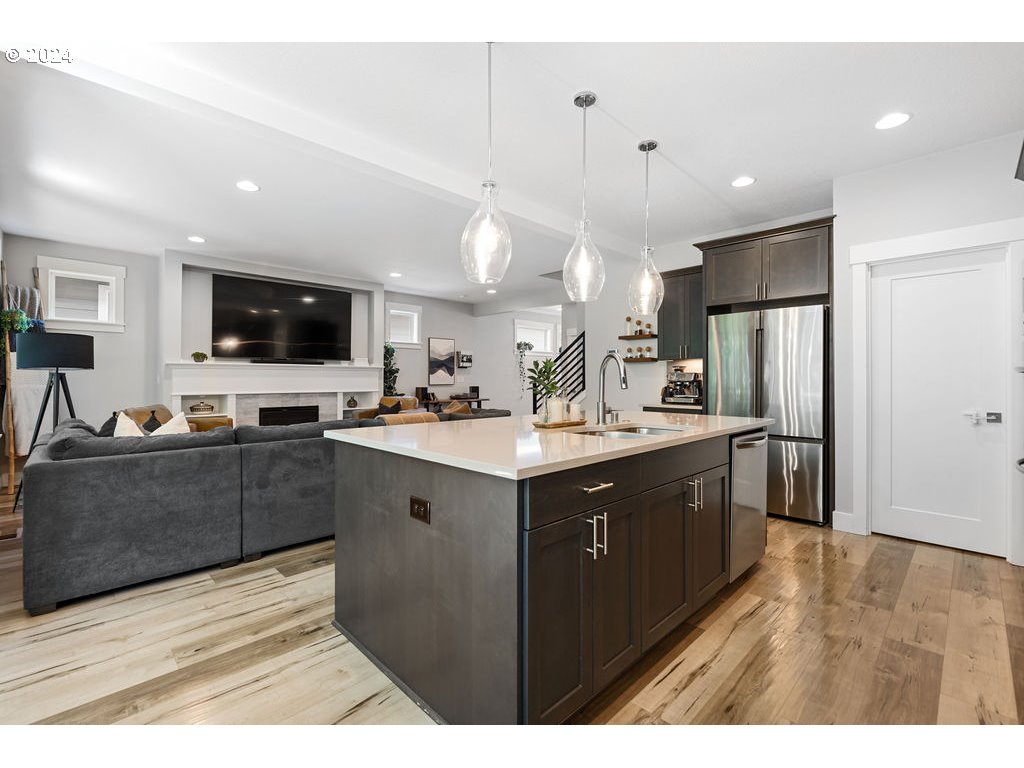 327 South 39th Drive Ridgefield, WA 98642 - Photo 10 of 48 a kitchen with a sink cabinets and stainless steel appliances