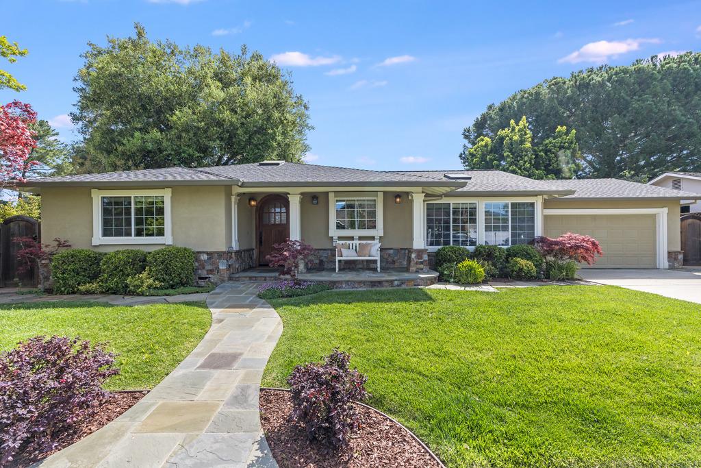 a view of a house with backyard sitting area and garden