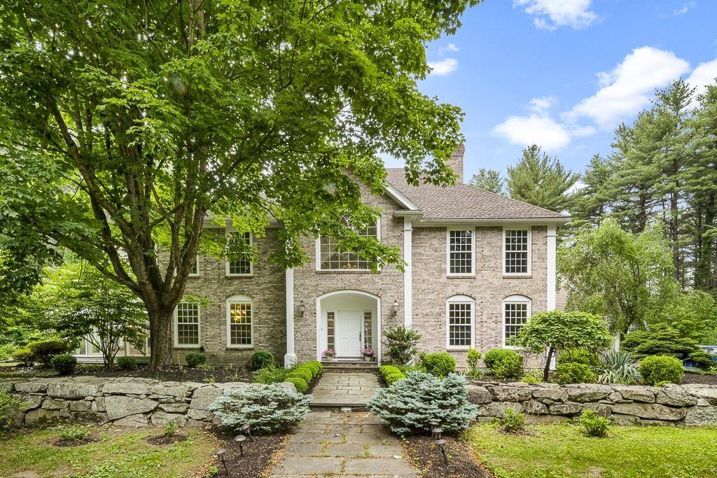 5 Duston Lane Acton, MA 01720 - Photo 1 of 39 a front view of a house with a garden