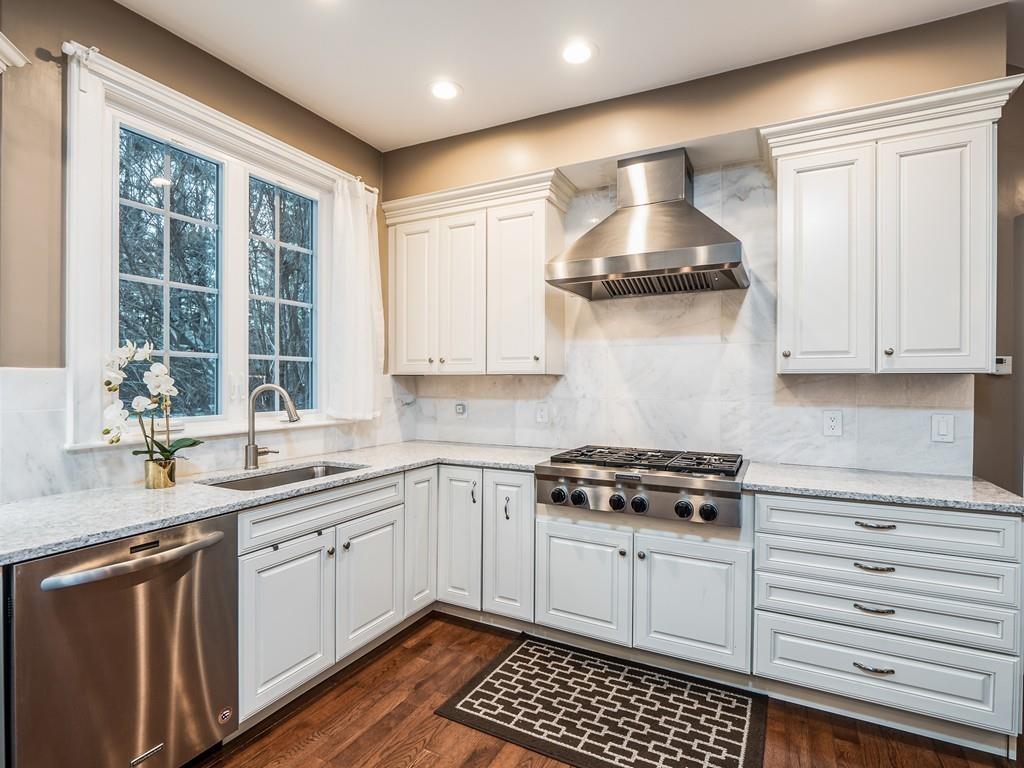 5 Duston Lane Acton, MA 01720 - Photo 12 of 39 a kitchen with stainless steel appliances a stove and white cabinets