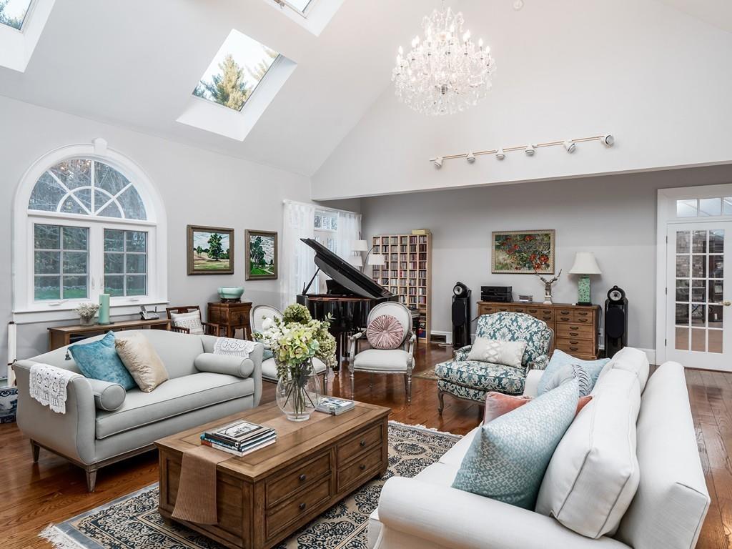 5 Duston Lane Acton, MA 01720 - Photo 17 of 39 a living room with furniture a chandelier and a window