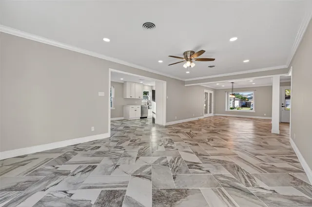 a view of a livingroom with a ceiling fan and window