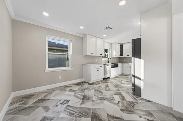 a kitchen with stainless steel appliances granite countertop a refrigerator sink and cabinets