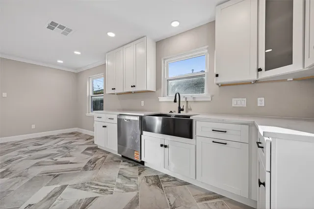 a kitchen with white cabinets and white appliances