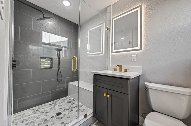 a bathroom with a sink toilet and shower