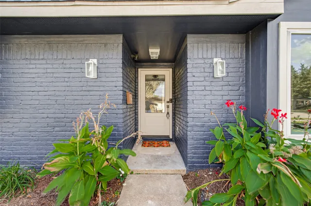 a bunch of flowers in front of the house