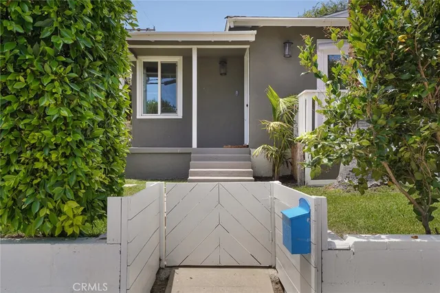 a view of entrance gate of the house and trees