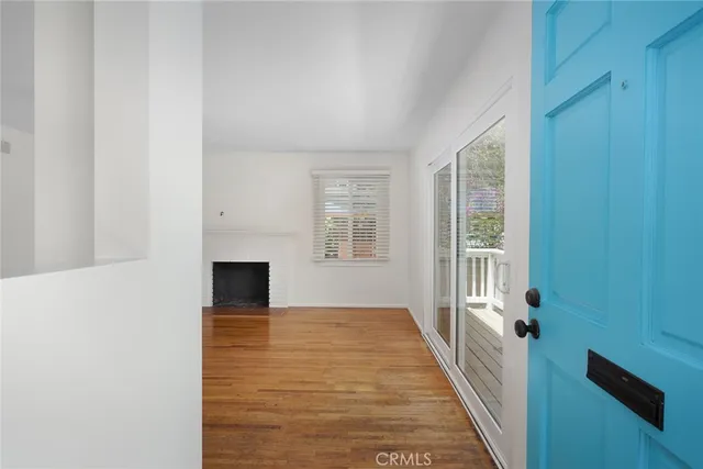 a view of a living room with furniture and a fireplace
