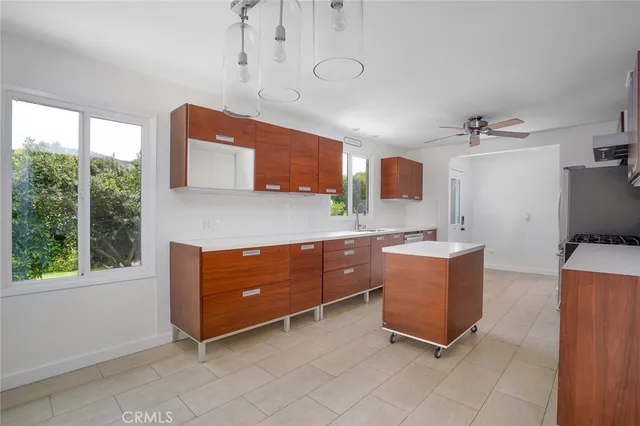 a room with a window and a dresser in it