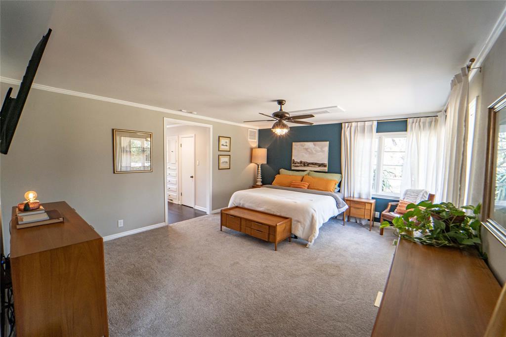 4 Sendero Road Breckenridge, TX 76424 - Photo 38 of 38 Large Primary Suite-split floor plan for added privacy, plenty of natural lighting and views of the wooded outdoors and also pool and patio!