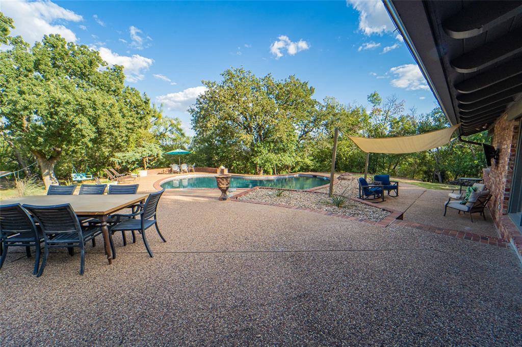 4 Sendero Road Breckenridge, TX 76424 - Photo 31 of 38 Outdoor entertaining made easy-sparkling pool, mature shade trees, multiple seating areas!