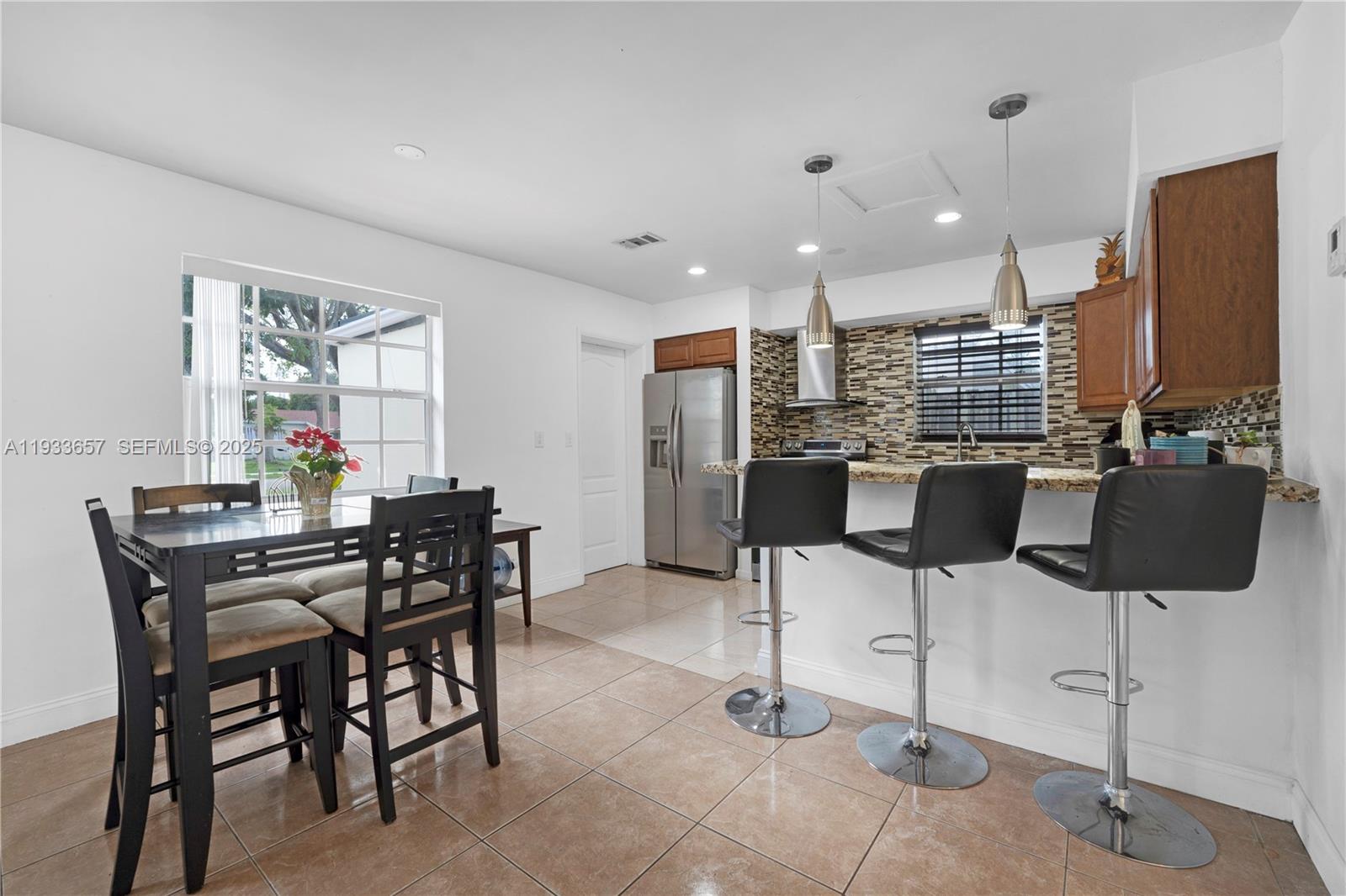 6841 Raleigh Street Hollywood, FL 33024 - Photo 12 of 41 a dining room with furniture and window