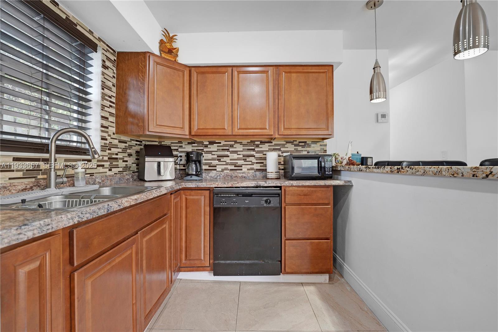6841 Raleigh Street Hollywood, FL 33024 - Photo 13 of 41 a kitchen with a sink stove and cabinets