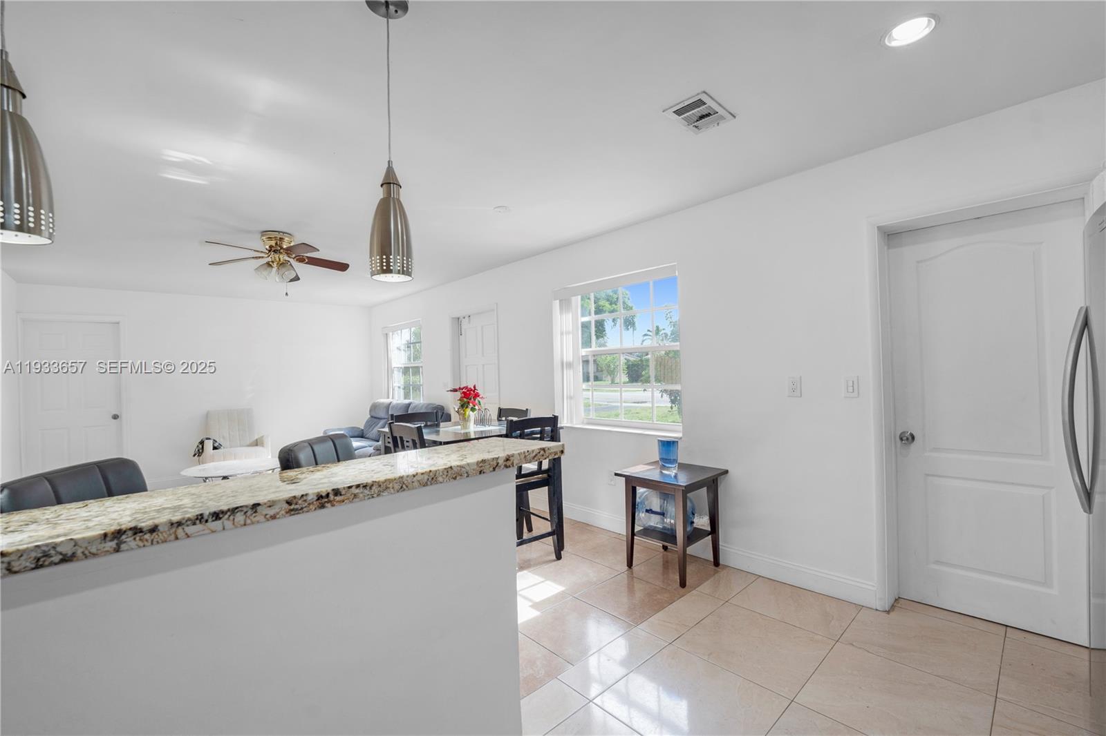 6841 Raleigh Street Hollywood, FL 33024 - Photo 15 of 41 a kitchen with a sink a stove a refrigerator and a window