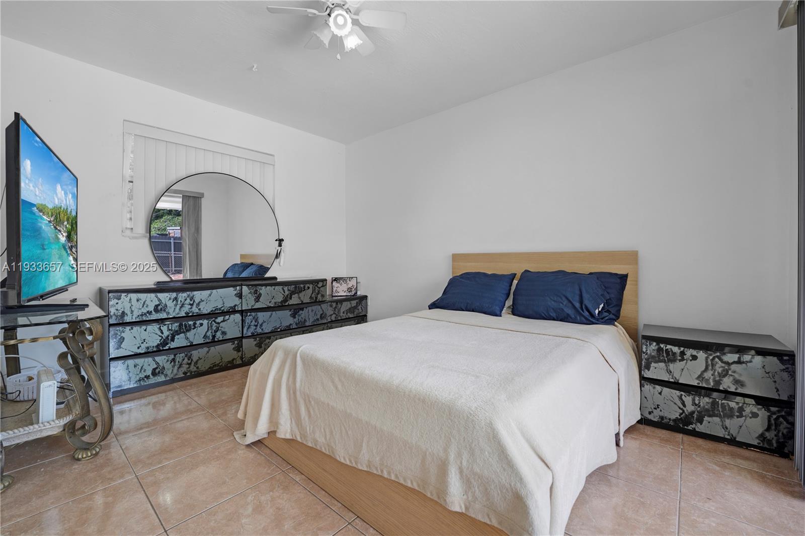 6841 Raleigh Street Hollywood, FL 33024 - Photo 16 of 41 a bedroom with two beds and a flat screen tv