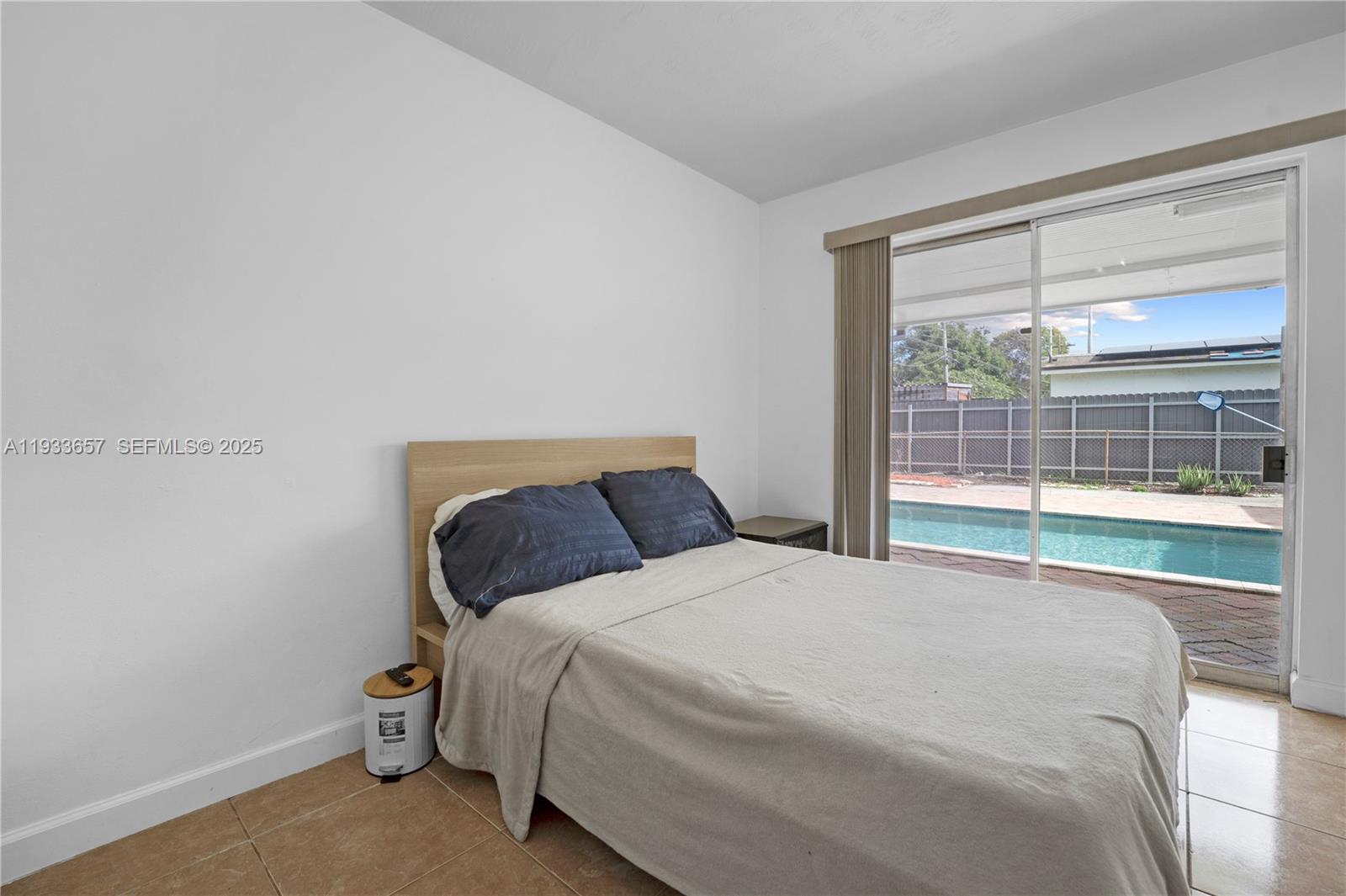6841 Raleigh Street Hollywood, FL 33024 - Photo 19 of 41 a bed sitting in a bedroom next to a window