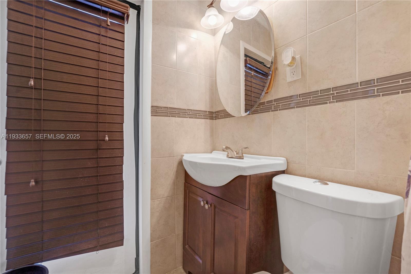 6841 Raleigh Street Hollywood, FL 33024 - Photo 32 of 41 a bathroom with a sink toilet and mirror