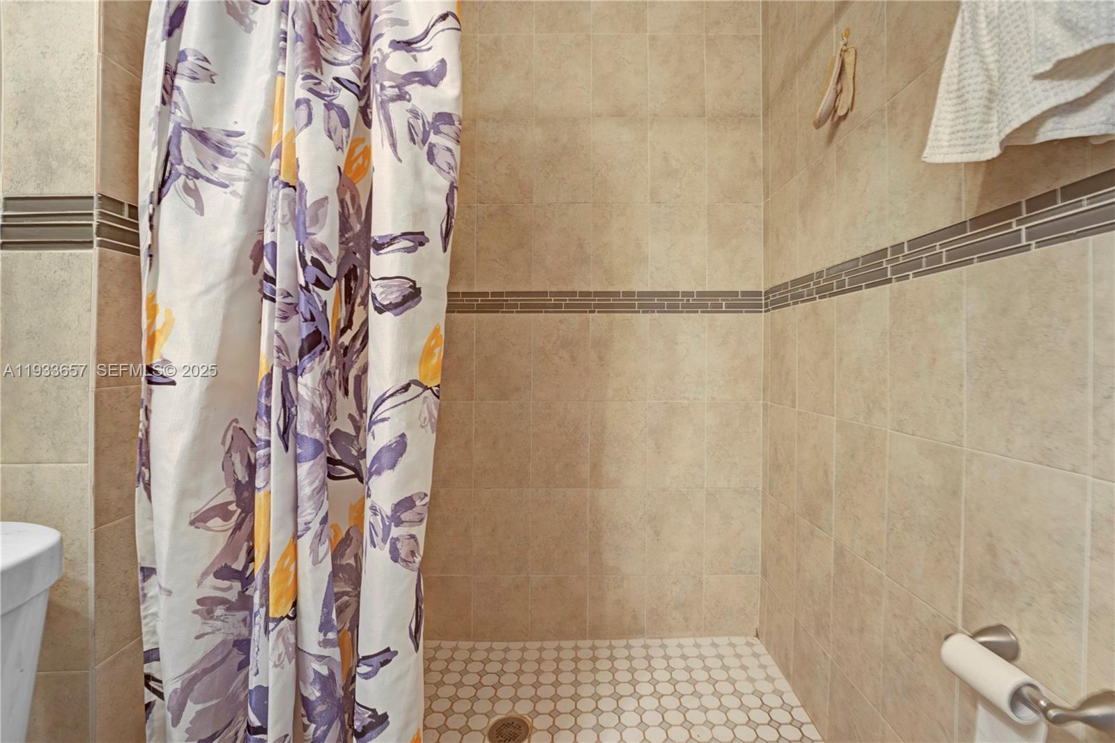 6841 Raleigh Street Hollywood, FL 33024 - Photo 33 of 41 a bathroom with a shower curtain