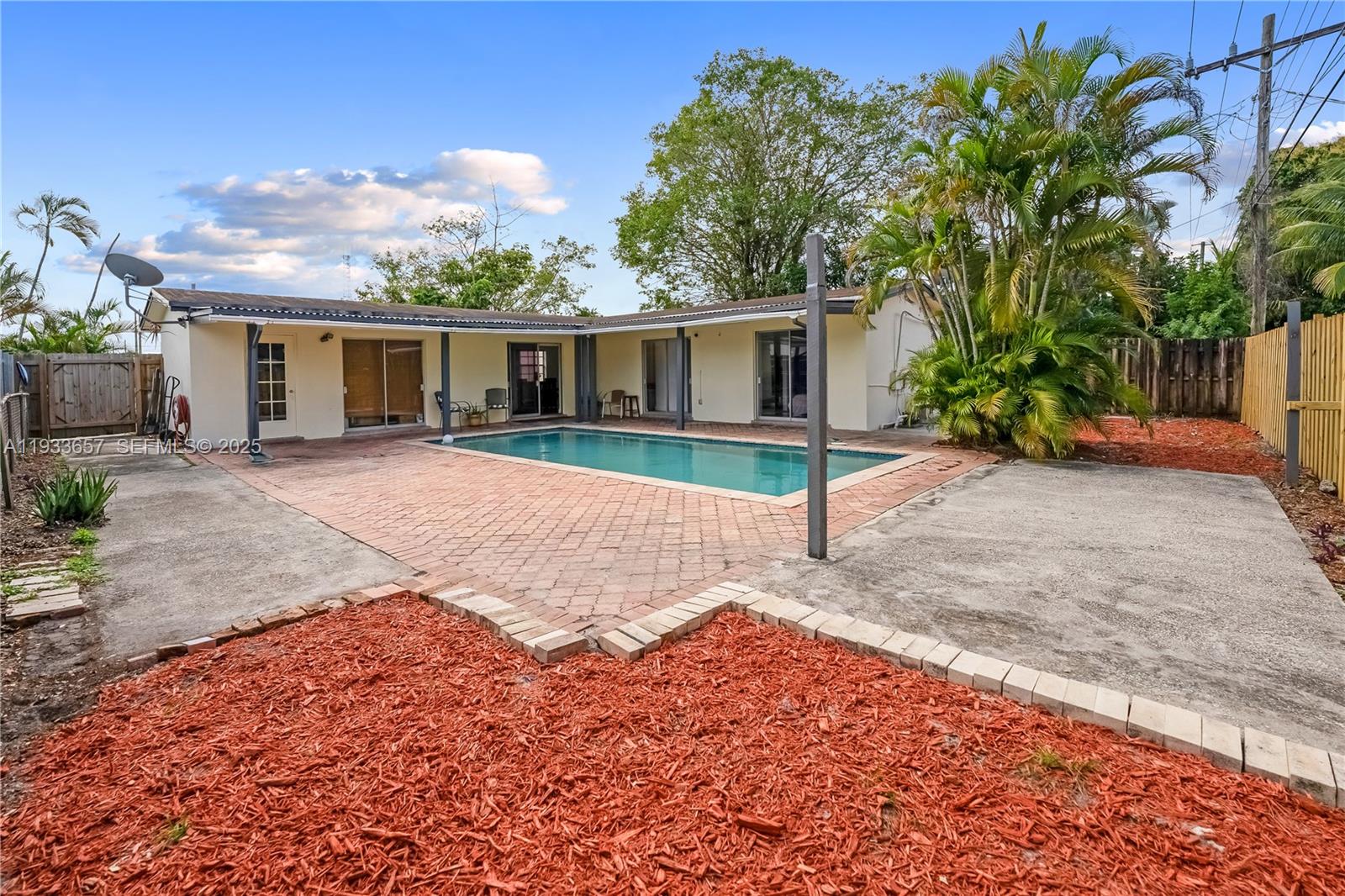 6841 Raleigh Street Hollywood, FL 33024 - Photo 35 of 41 a view of a backyard with plants and a large tree