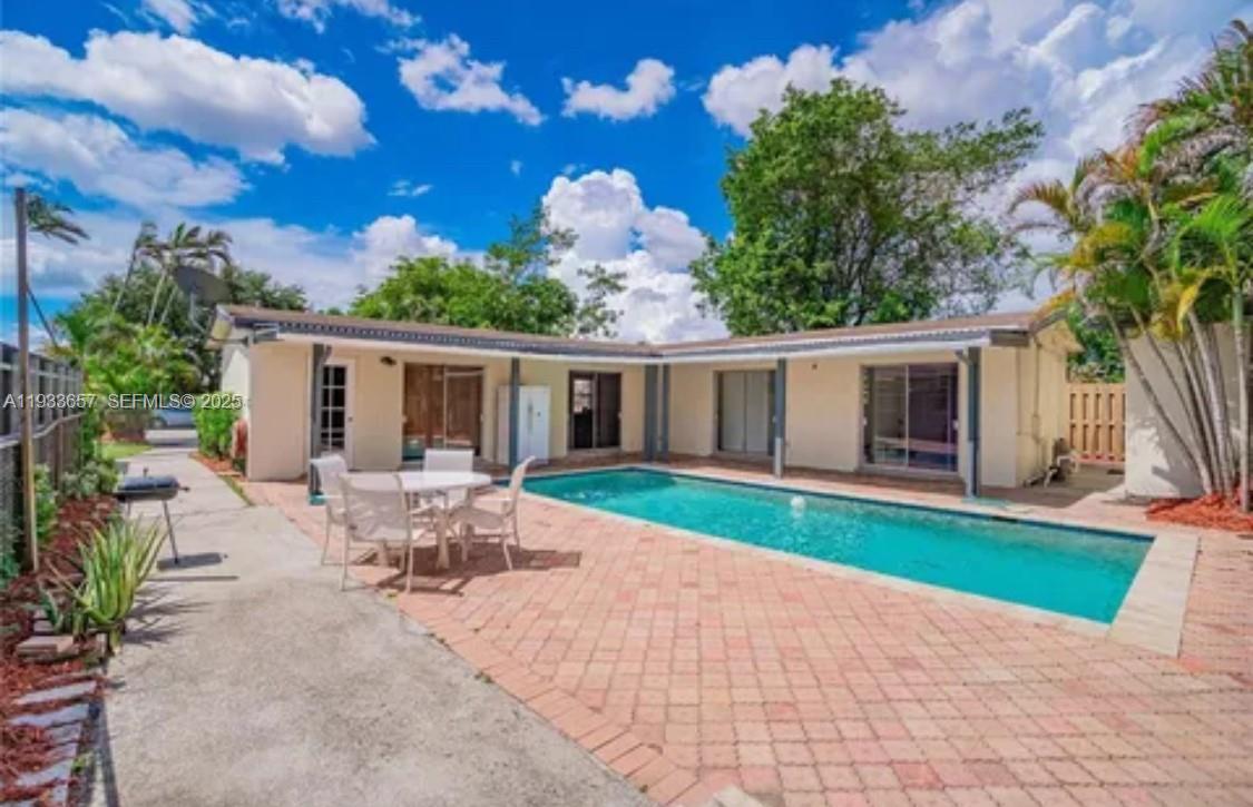 6841 Raleigh Street Hollywood, FL 33024 - Photo 40 of 41 a view of a house with backyard and sitting area