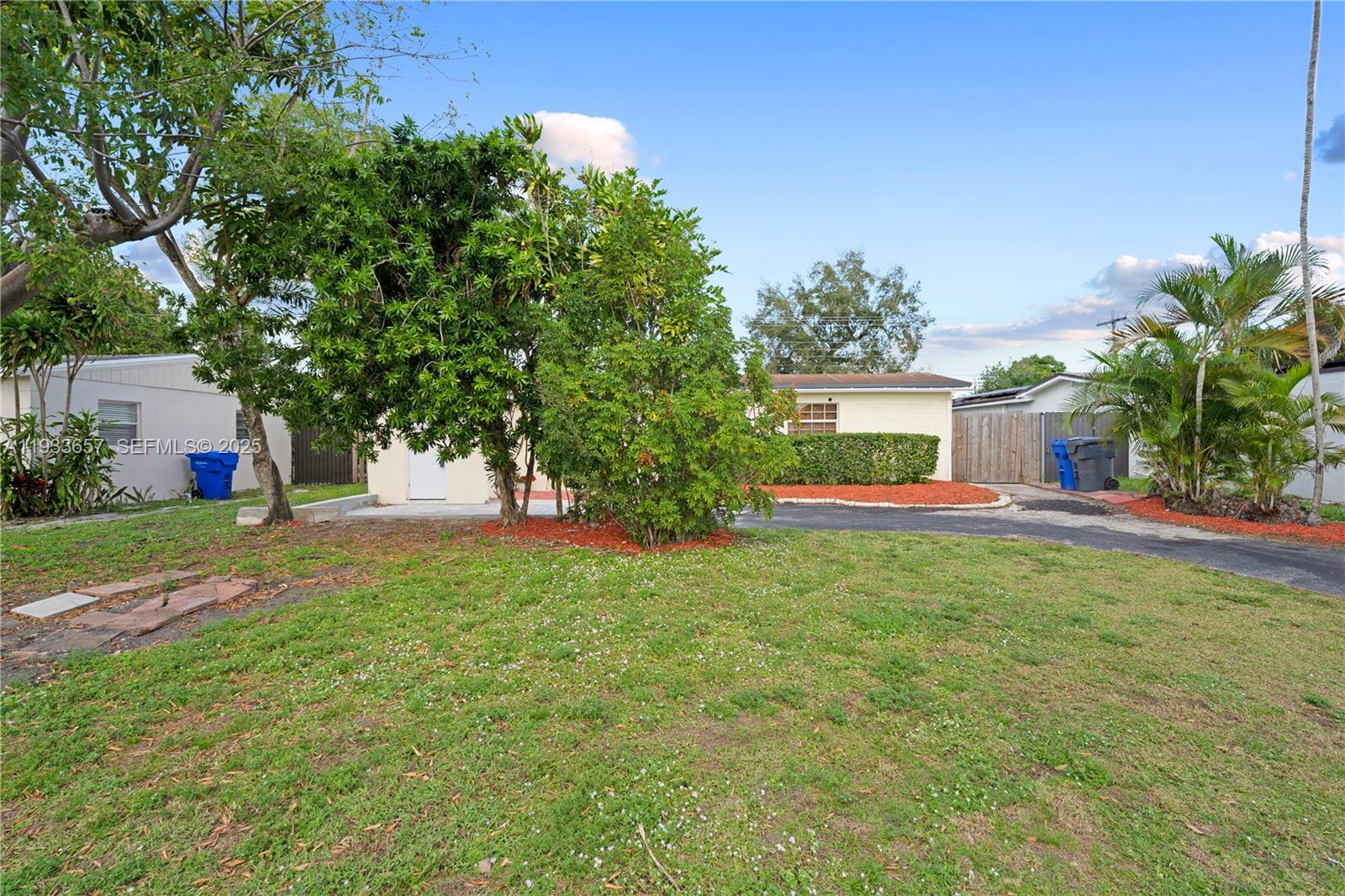6841 Raleigh Street Hollywood, FL 33024 - Photo 6 of 41 a front view of a house with garden