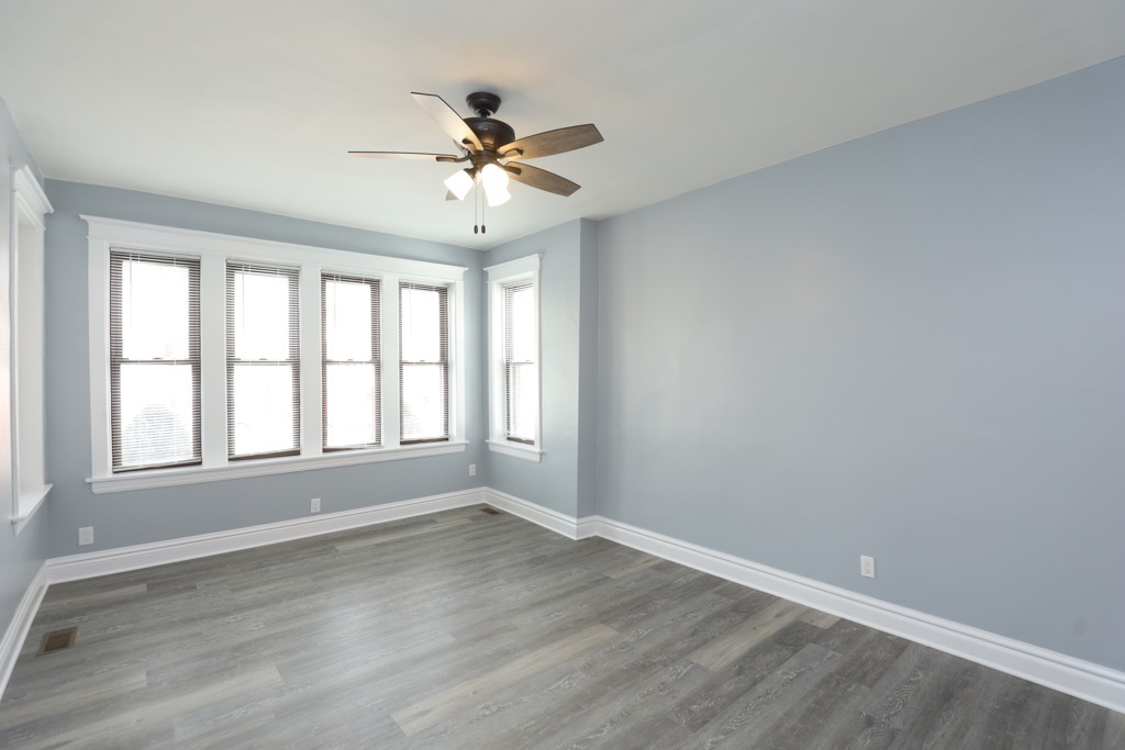 2039 West 23rd Street, Unit 1 Chicago, IL 60608 - Photo 11 of 20 a view of empty room with wooden floor and fan