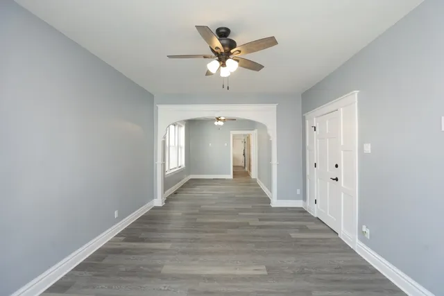a view of an empty room with a fan