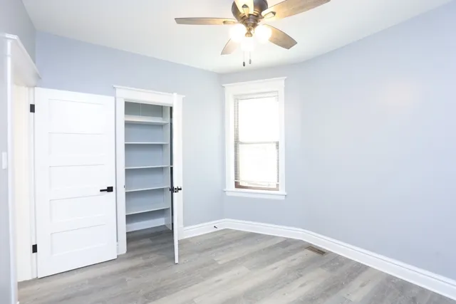 wooden floor in an empty room with a window