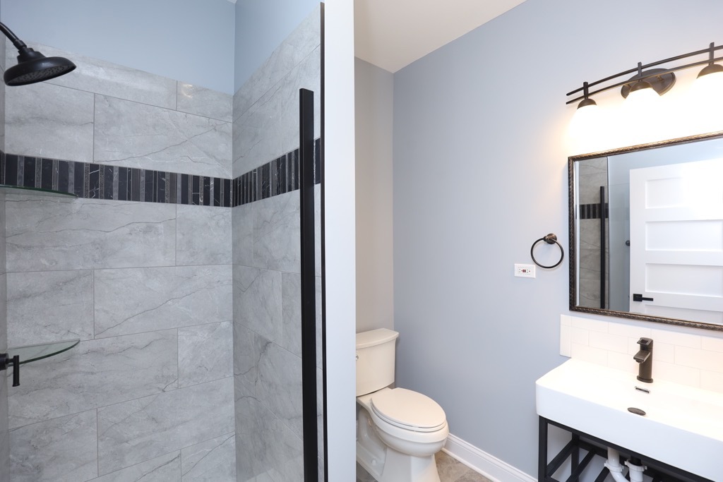 2039 West 23rd Street, Unit 1 Chicago, IL 60608 - Photo 19 of 20 a bathroom with a sink toilet and shower