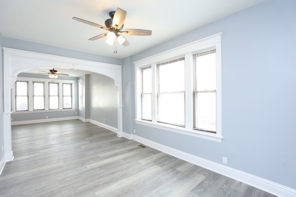 2039 West 23rd Street, Unit 1 Chicago, IL 60608 - Photo 6 of 20 an empty room with wooden floor and windows