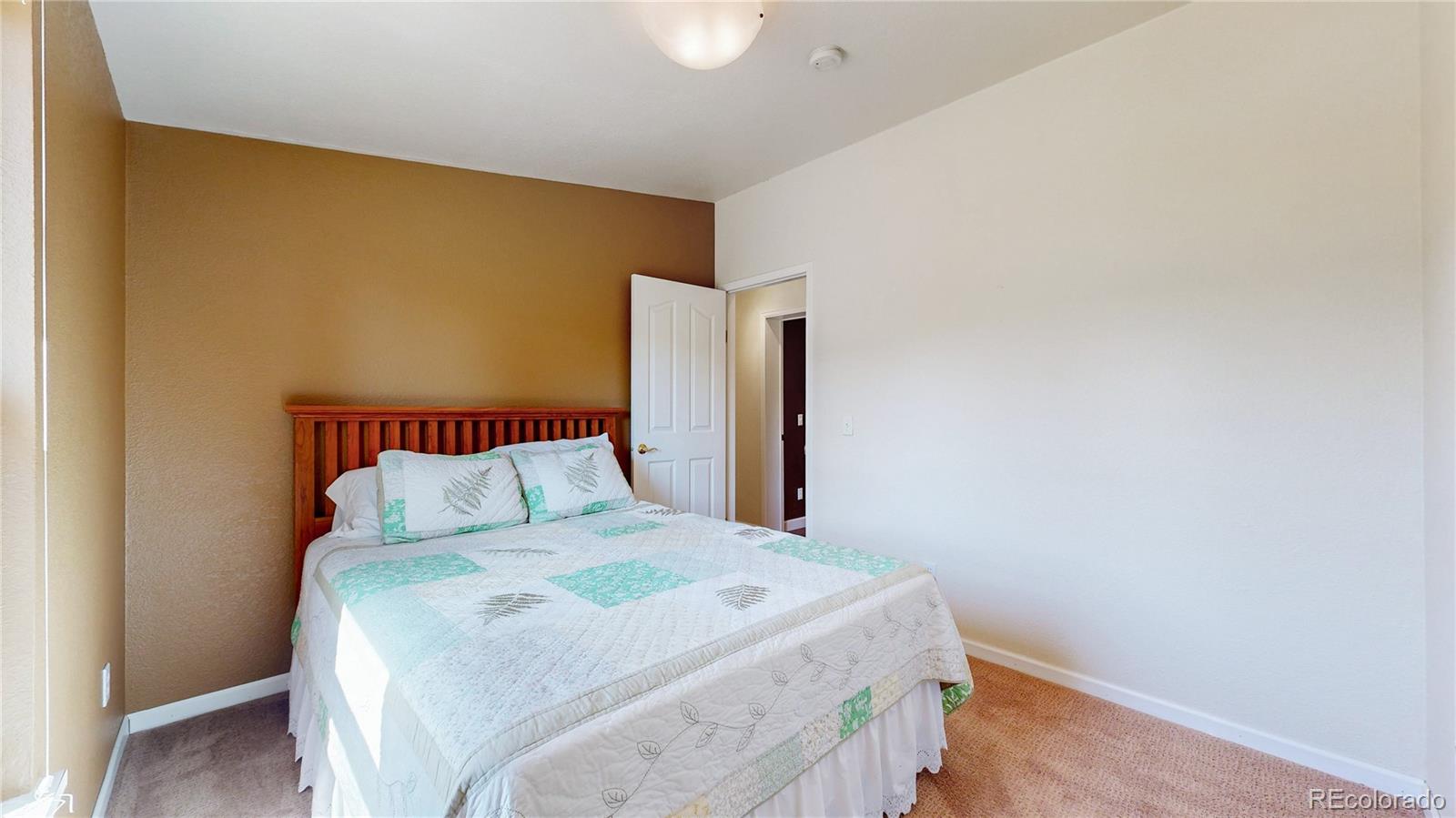 53 O'Brien Road Bailey, CO 80421 - Photo 19 of 49 a bedroom with a bed and a wall painting