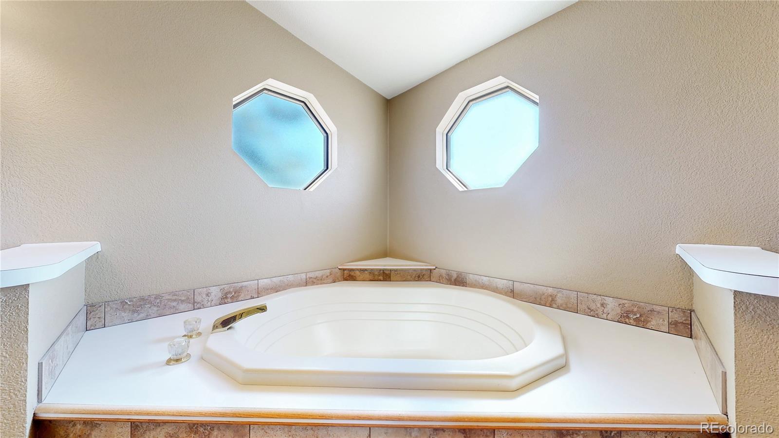 53 O'Brien Road Bailey, CO 80421 - Photo 25 of 49 a bathroom with a bathtub and mirror