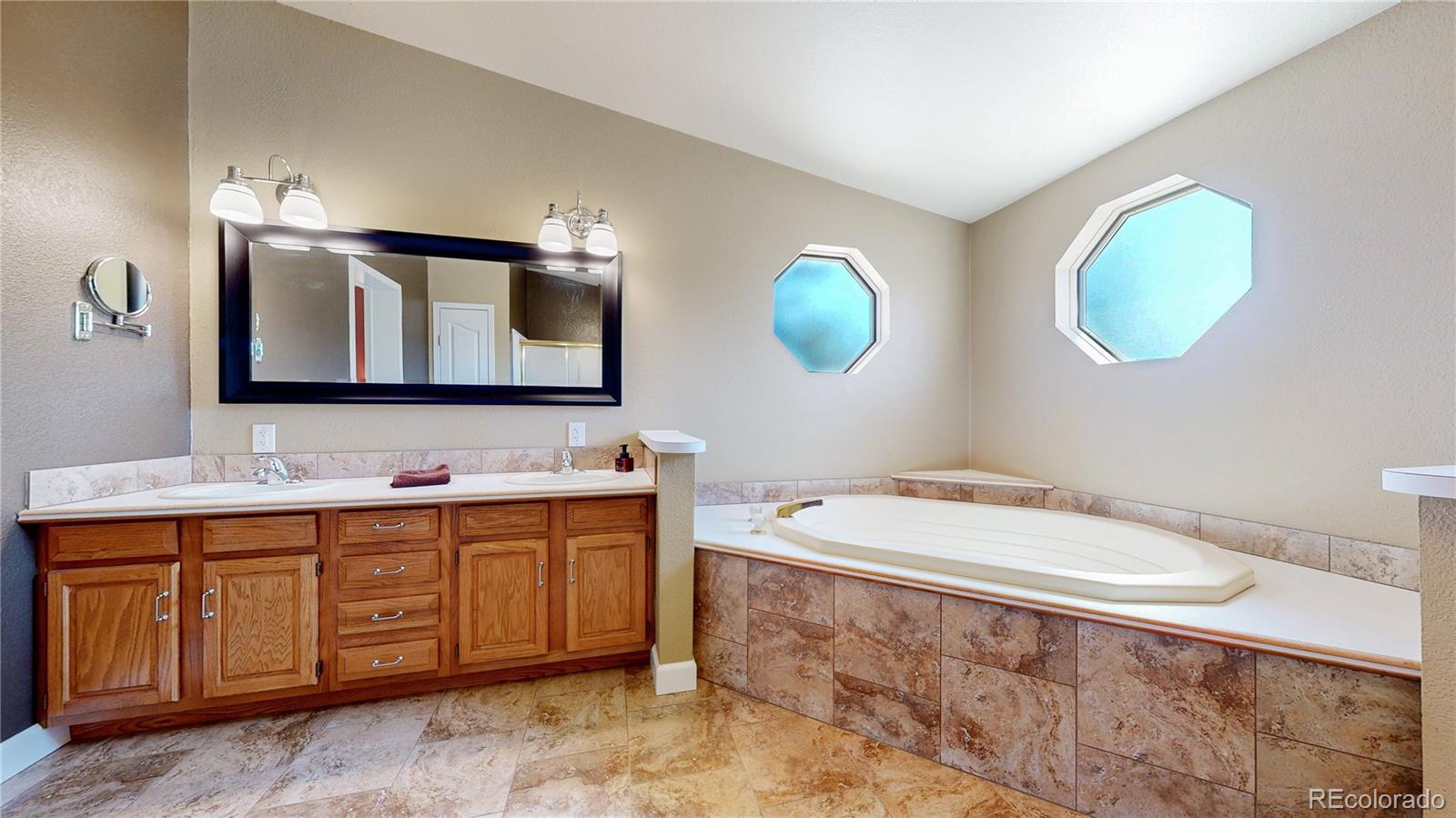 53 O'Brien Road Bailey, CO 80421 - Photo 26 of 49 a bathroom with a toilet a sink and mirror