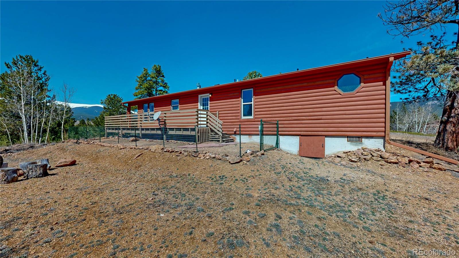 53 O'Brien Road Bailey, CO 80421 - Photo 38 of 49 a backyard of a house with barbeque oven table and chairs