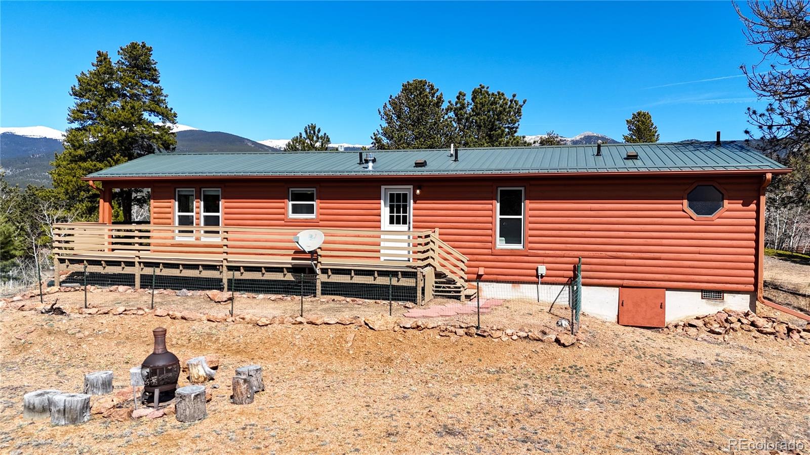 53 O'Brien Road Bailey, CO 80421 - Photo 40 of 49 a backyard of a house with table and chairs