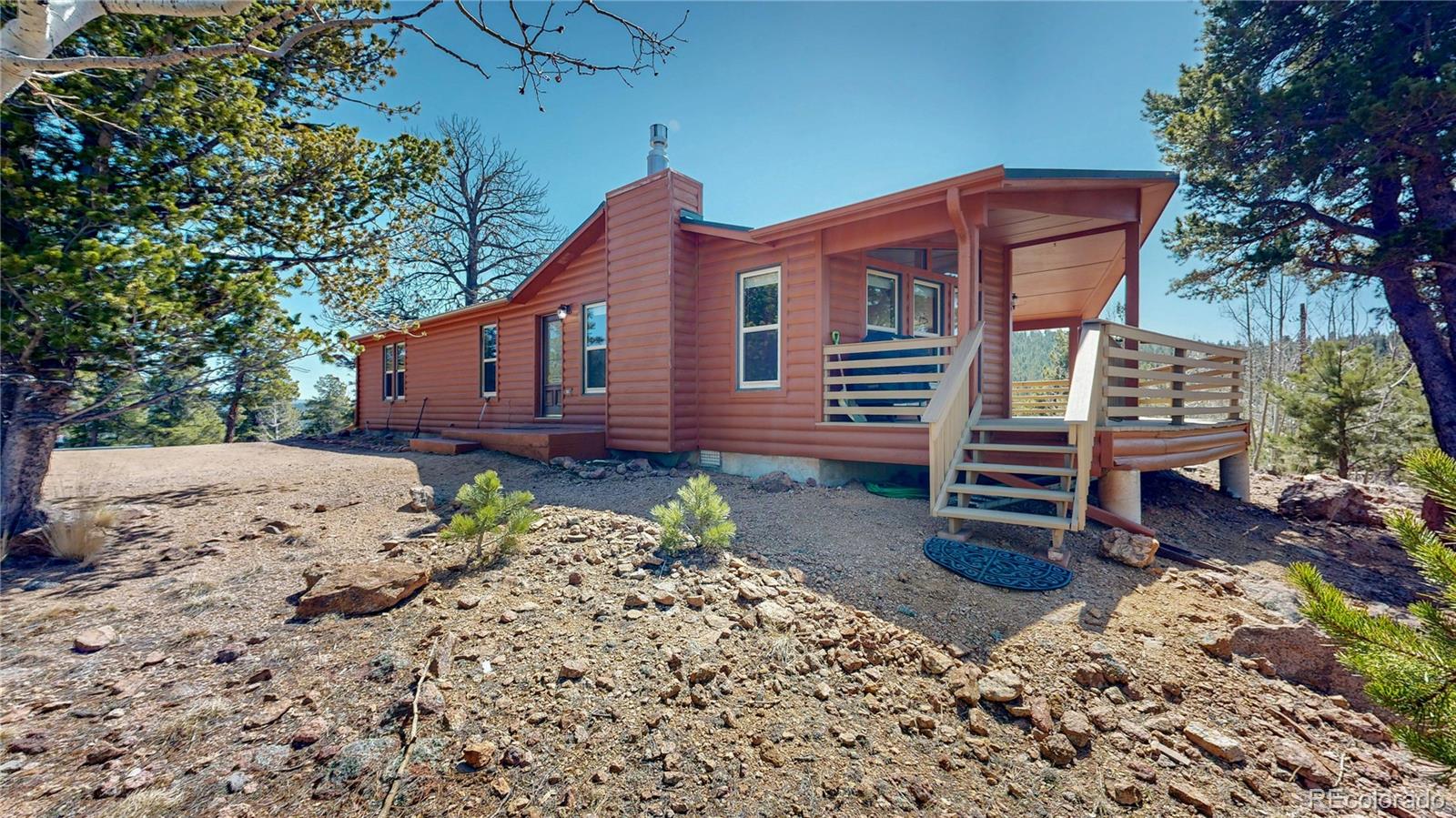 53 O'Brien Road Bailey, CO 80421 - Photo 4 of 49 a backyard of a house with a large tree