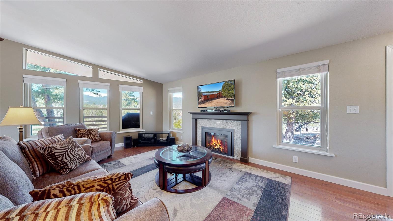 53 O'Brien Road Bailey, CO 80421 - Photo 7 of 49 a living room with furniture and a fireplace