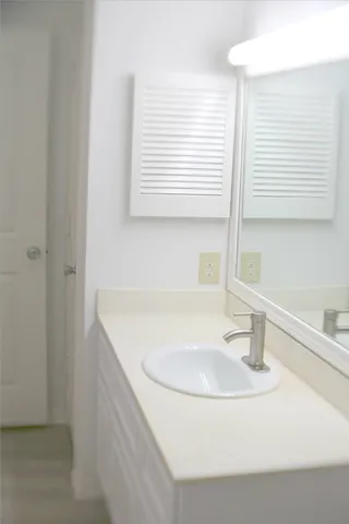 a bathroom with a sink and a window