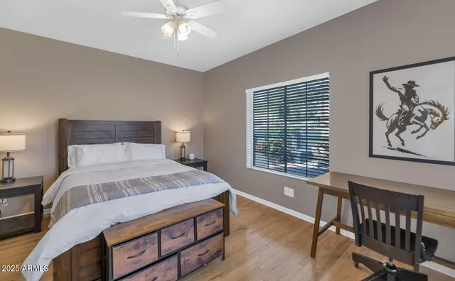 a bedroom with a bed window and a table